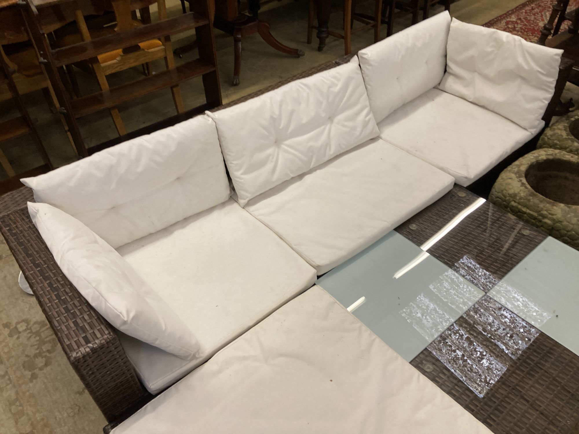 A rattan garden sofa, foot stool and glass top table, sofa width 210cm depth 70cm height 54cm